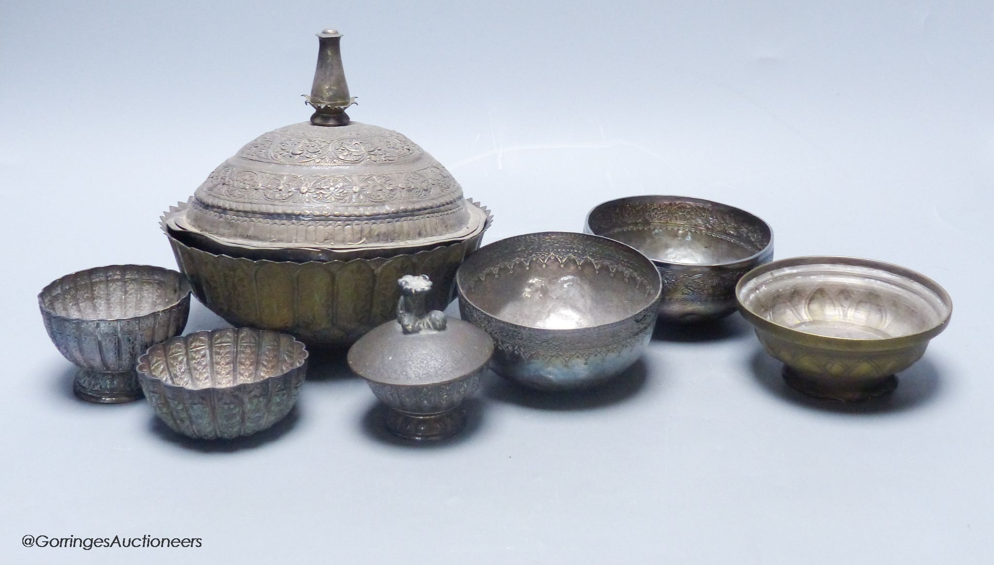 A Malay Straits pedestal bowl and cover or 'Batil Ber Tutop' (a.f.), three Malay Straits white metal betel nut cups and two similar small bowls